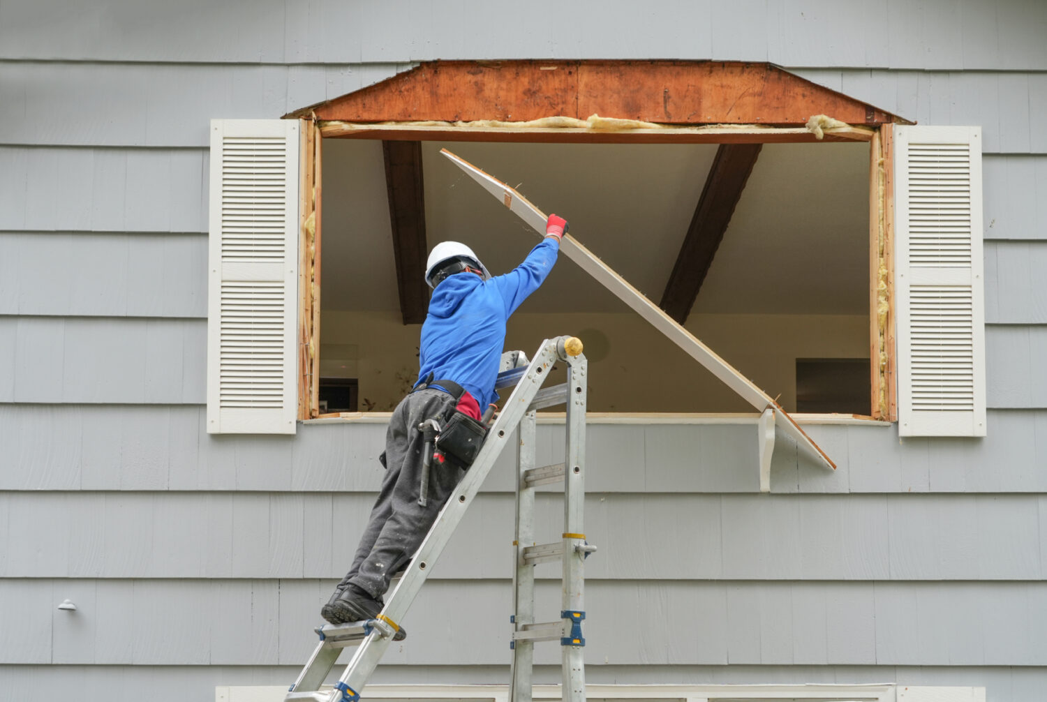 contractor working on replacing the window of the house